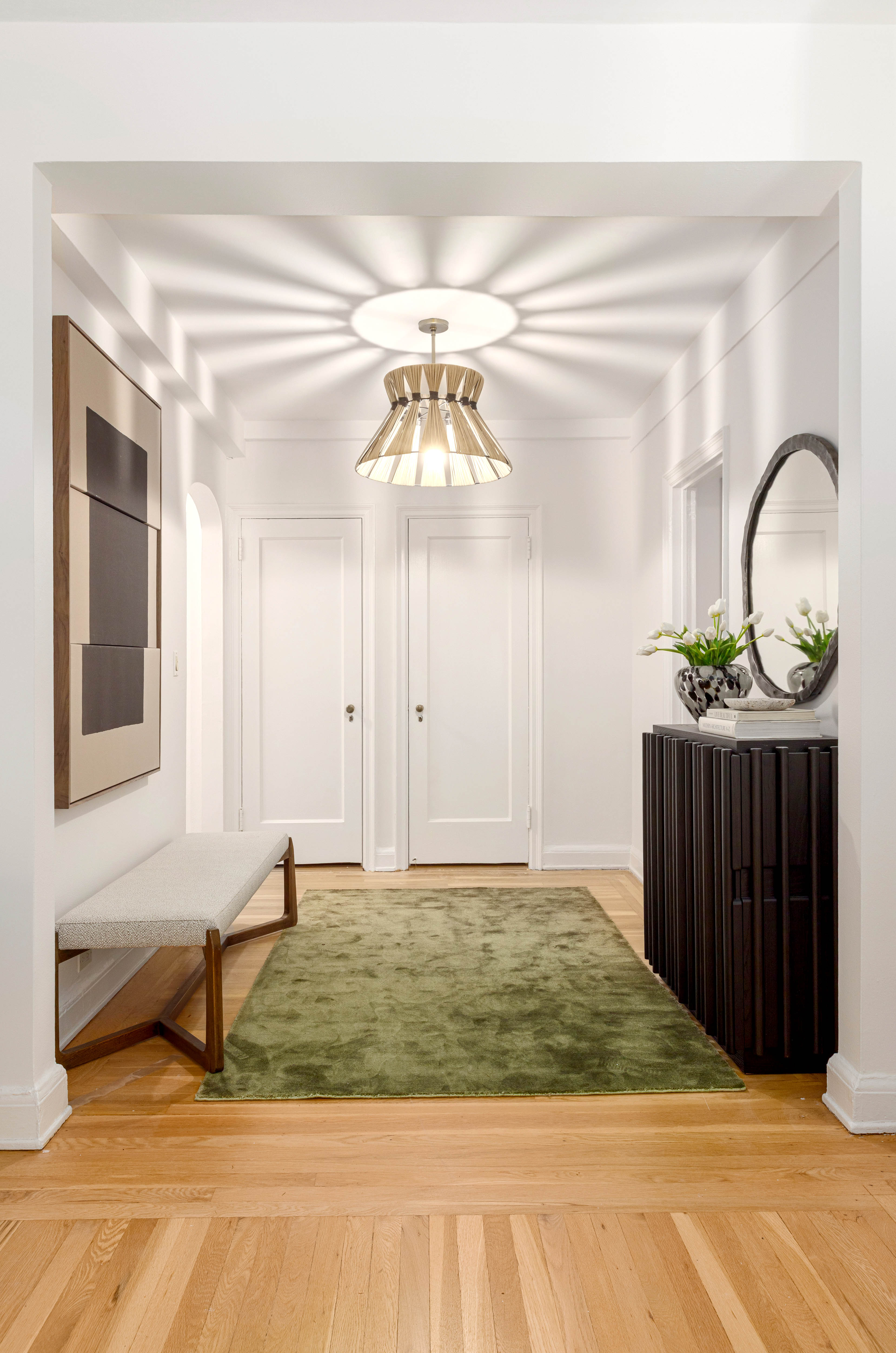 400 East 52nd Street, Unit 10K Manhattan, NY 10022 - Photo 4 of 6 a view of a room with a sink and mirror