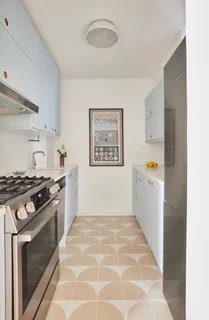 a kitchen with stainless steel appliances granite countertop a stove and a refrigerator