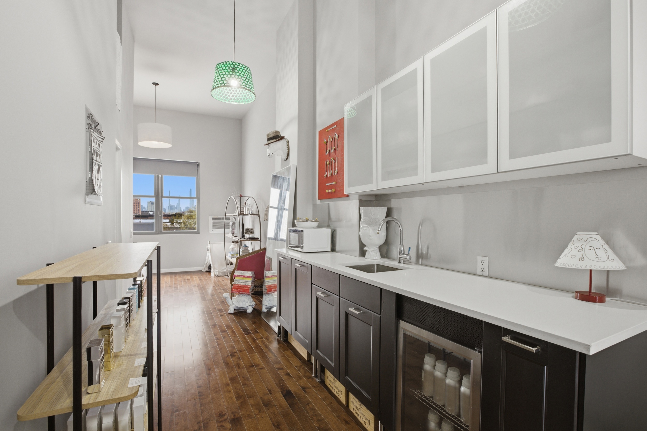 127 West 123rd Street Manhattan, NY 10027 - Photo 20 of 28 a kitchen with a sink dishwasher a stove and a dining table with wooden floor