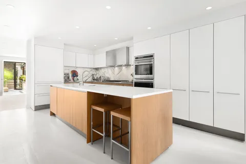 a kitchen with kitchen island cabinets and refrigerator
