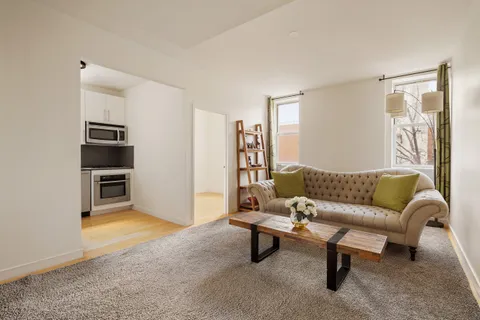 a living room with furniture and a rug