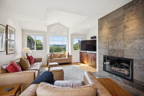 a living room with furniture fireplace and flat screen tv