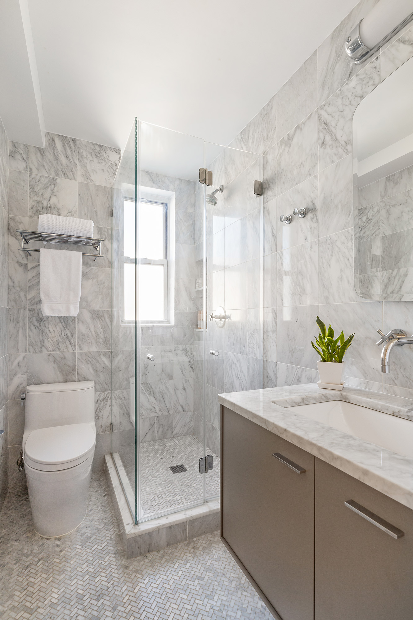 425 East 86th Street, Unit 11E Manhattan, NY 10028 - Photo 11 of 19 a bathroom with a granite countertop sink a toilet and shower