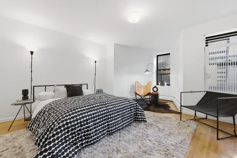 a bedroom with a large bed and a window