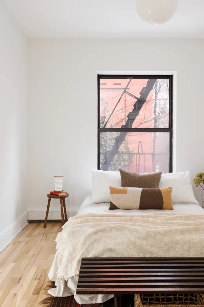 a bedroom with a bed and window