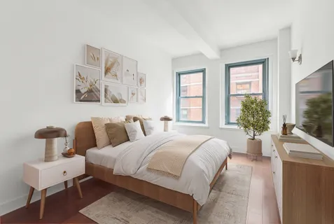 a bedroom with a bed and large window
