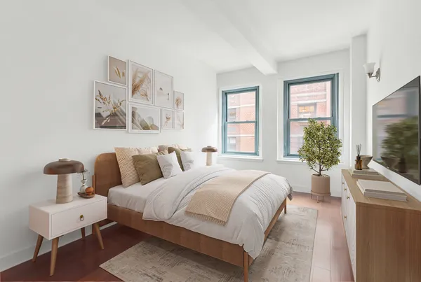 a bedroom with a bed and large window