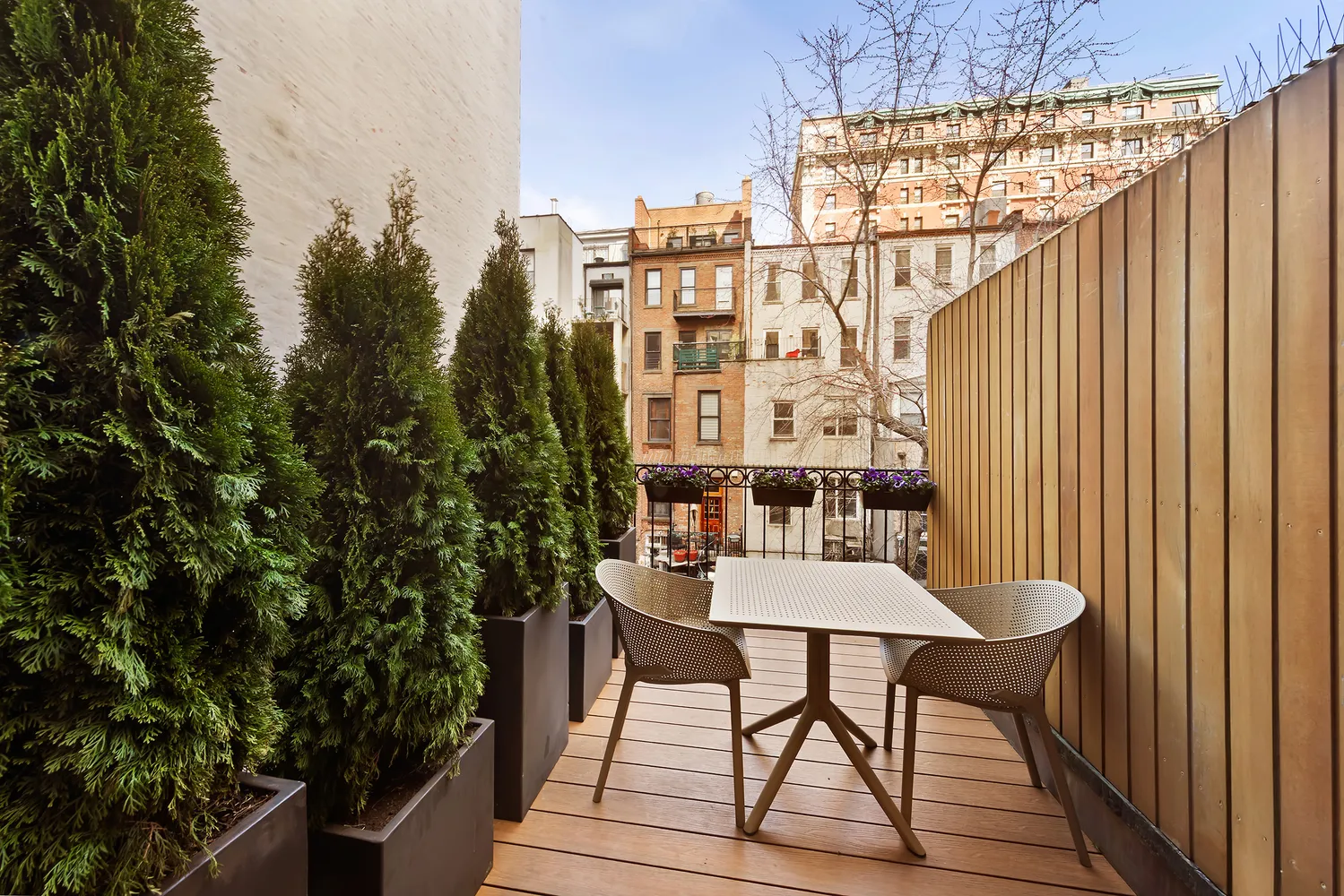 a view of a balcony dining table and chairs