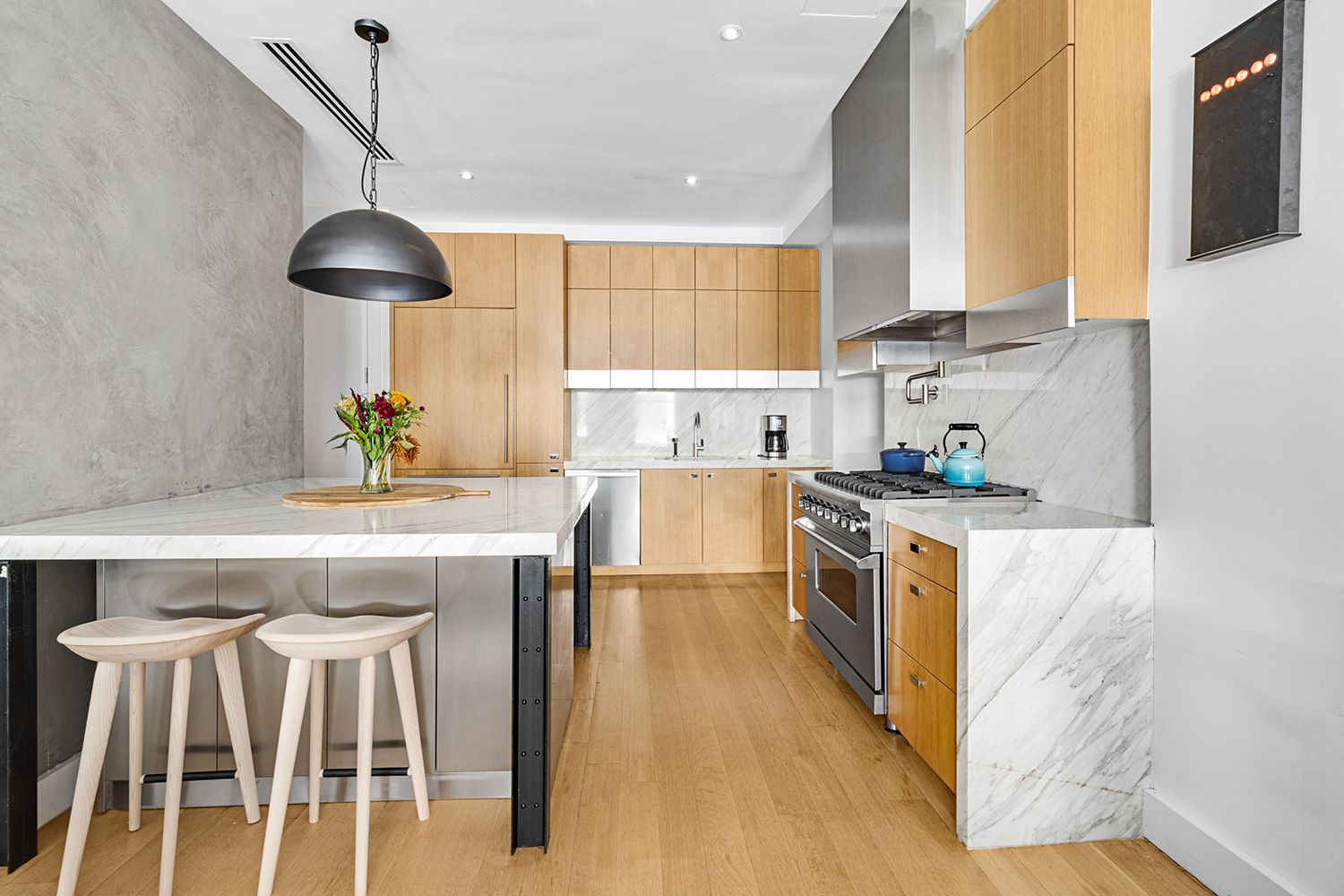 a kitchen with granite countertop a sink a center island and stainless steel appliances