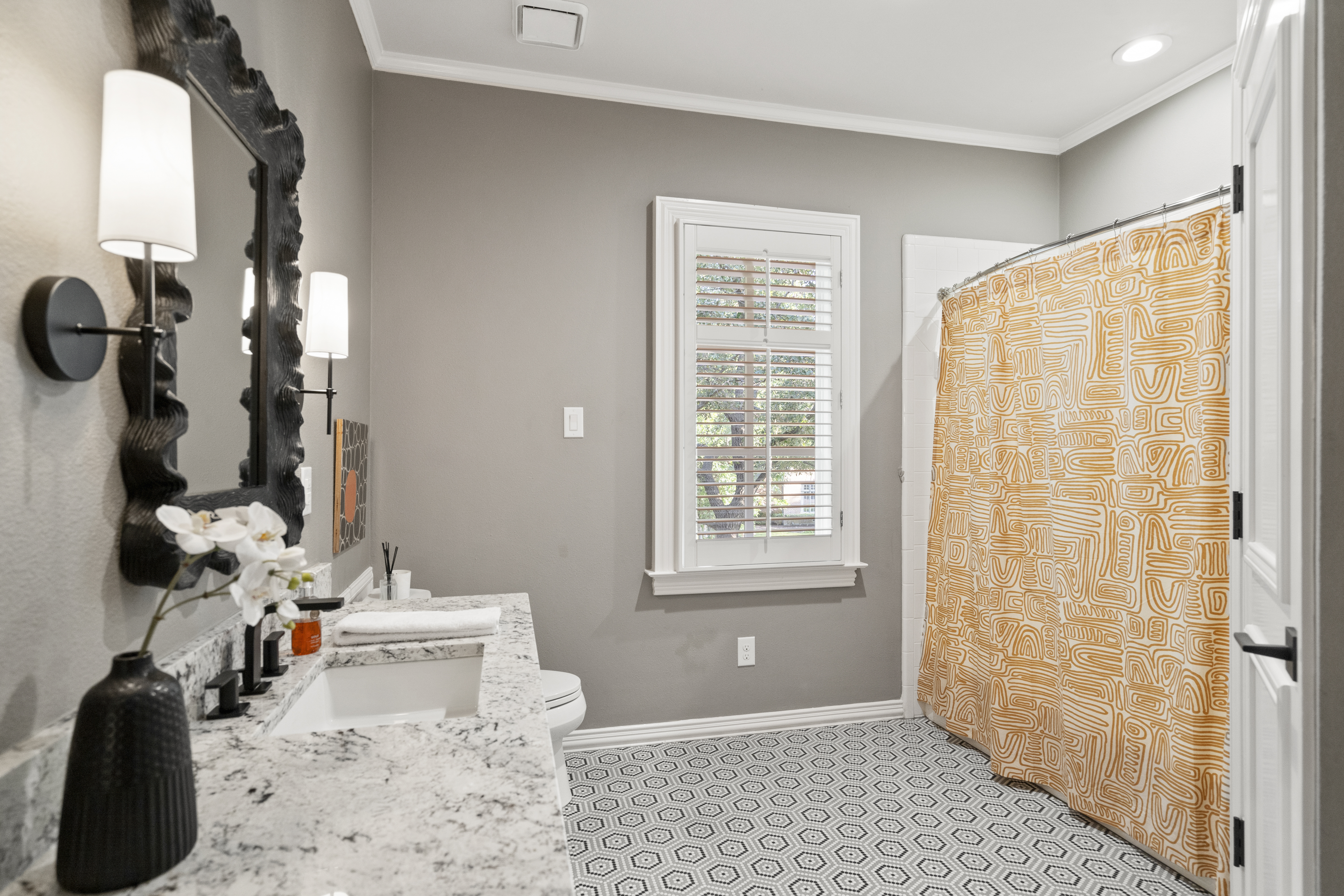 6607 Meadow Road Dallas, TX 75230 - Photo 22 of 32 a bathroom with a sink toilet and shower