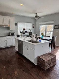 a kitchen with a sink stove and cabinets
