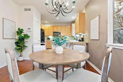 a dining room with furniture and a potted plant