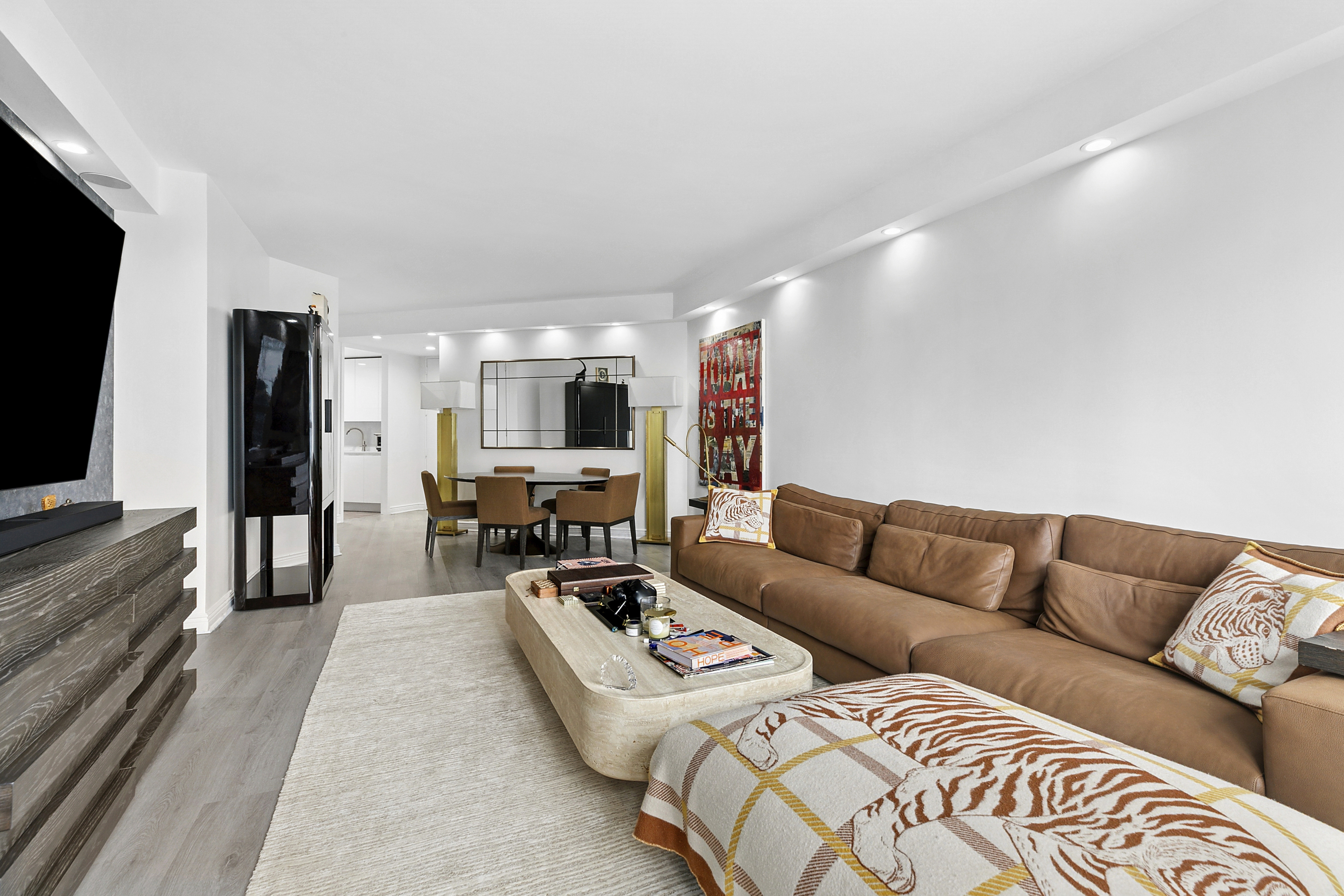 146 West 57th Street, Unit 47B Manhattan, NY 10019 - Photo 3 of 15 a living room with furniture and a flat screen tv