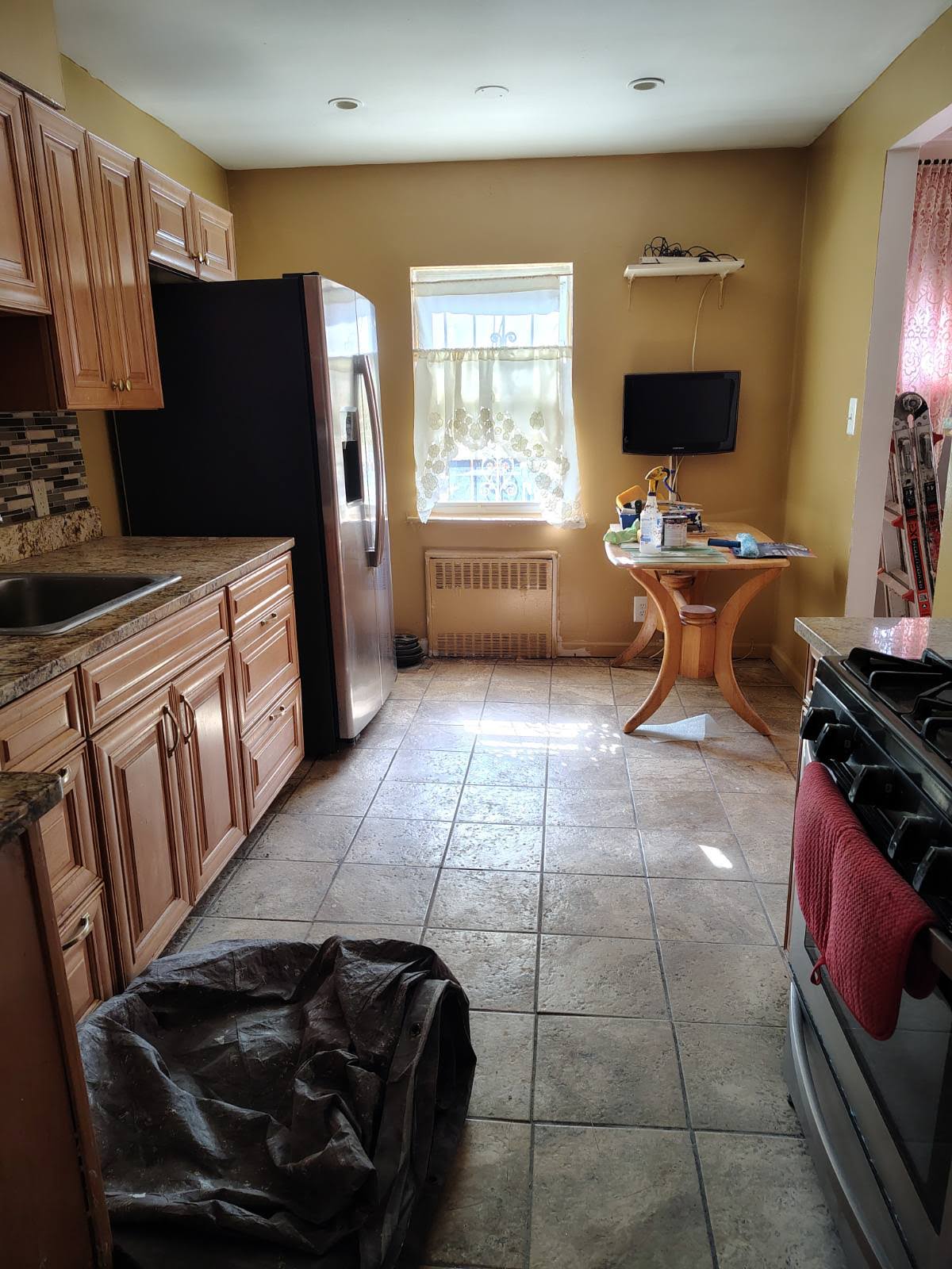 a kitchen with stainless steel appliances a stove a sink and a refrigerator