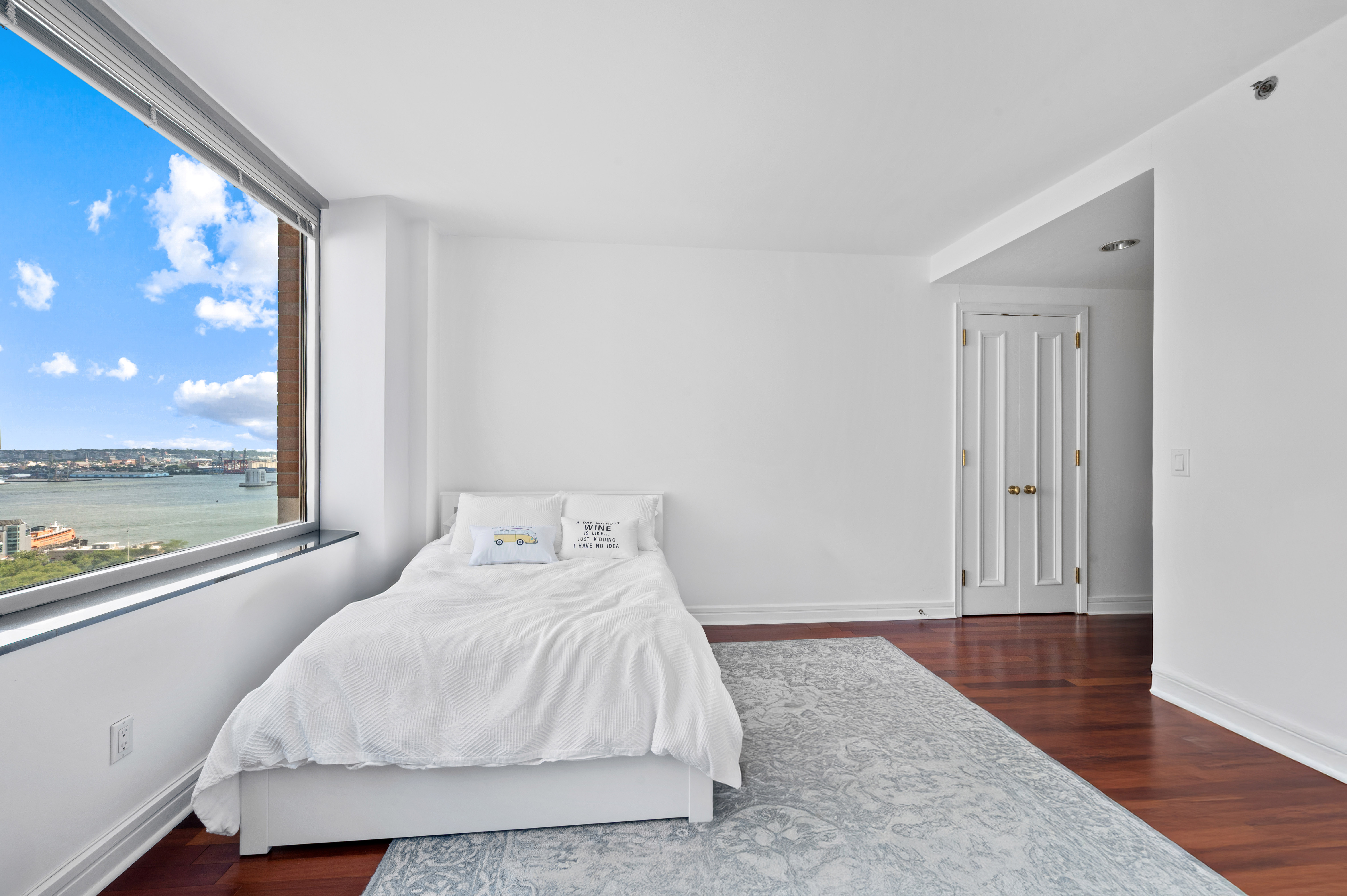 10 West Street, Unit 28C Manhattan, NY 10004 - Photo 8 of 12 a bedroom with a bed and window