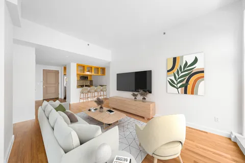 a living room with furniture a flat screen tv and a floor to ceiling window