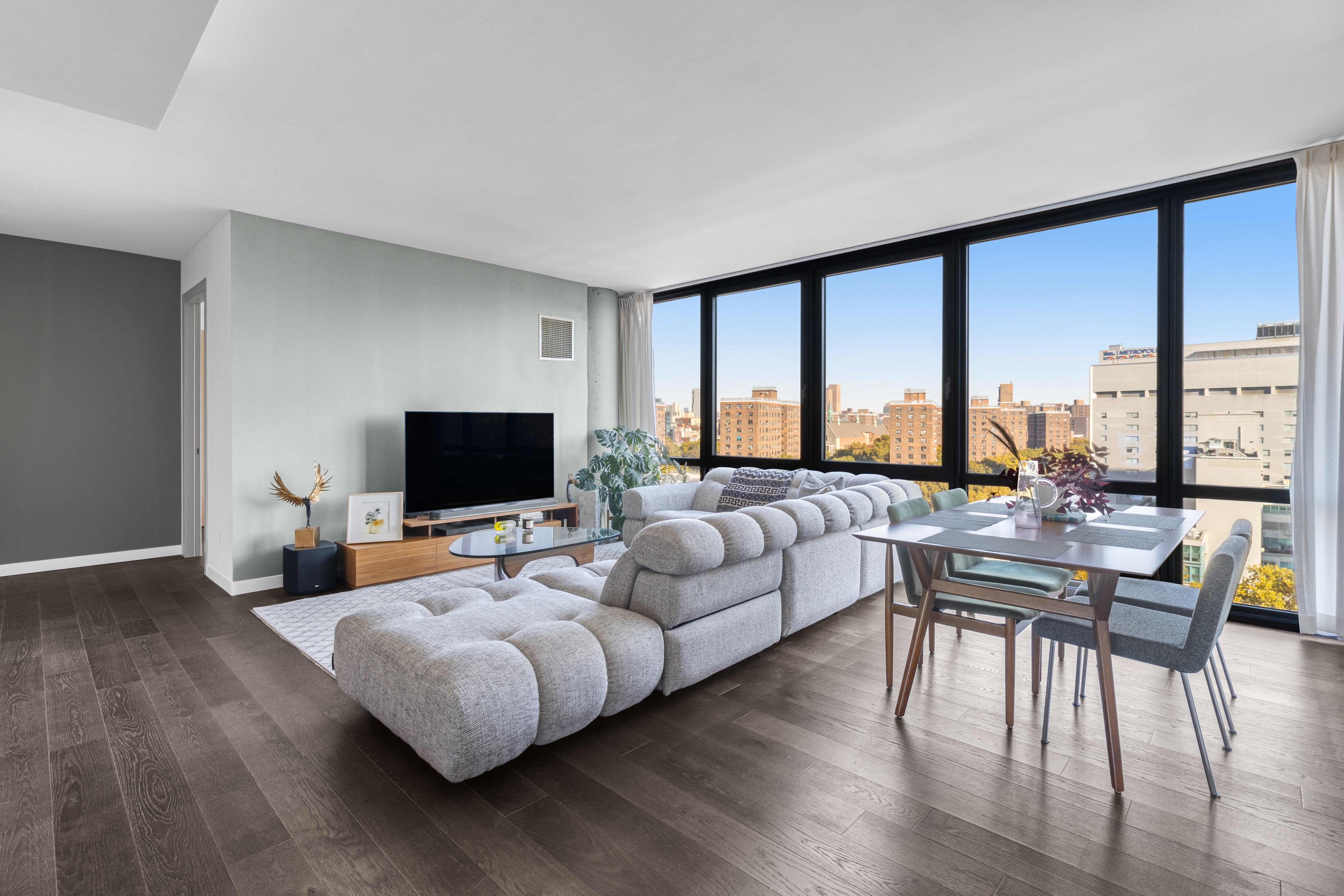 302 East 96th Street, Unit 1103 Manhattan, NY 10128 - Photo 2 of 22 a living room with furniture and a flat screen tv
