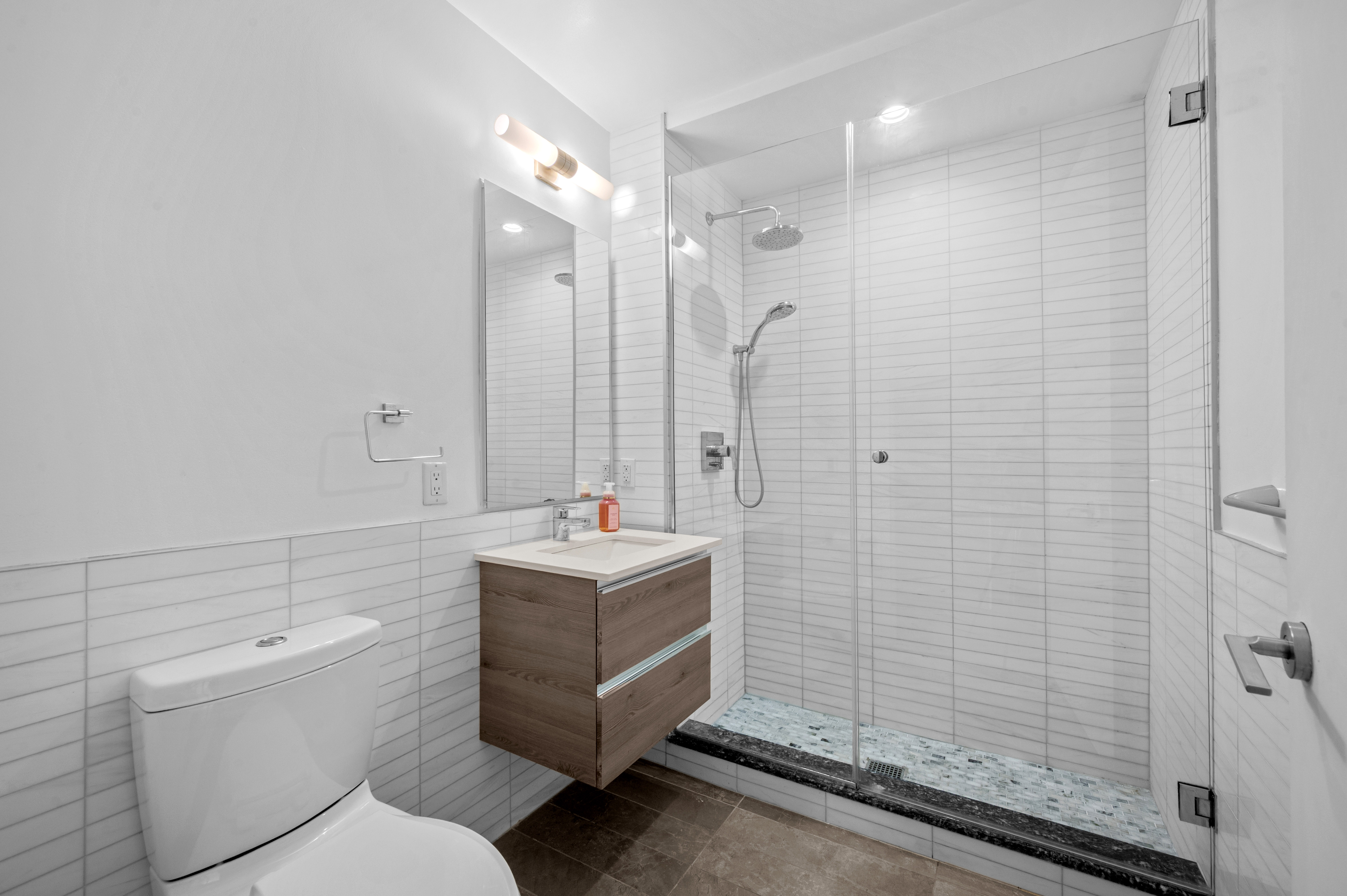 17 Convent Avenue Manhattan, NY 10027 - Photo 10 of 15 a bathroom with a granite countertop sink a toilet and shower