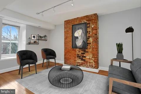 a living room with furniture and a painting