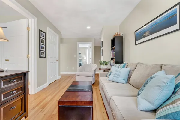 a living room with furniture and a wooden floor