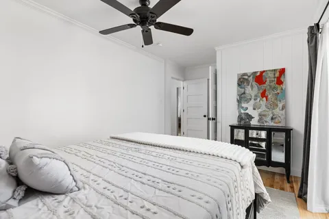 a bedroom with a bed and a painting on the wall