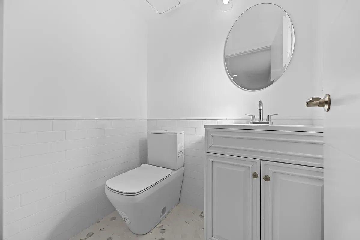 a bathroom with a toilet a sink and a mirror