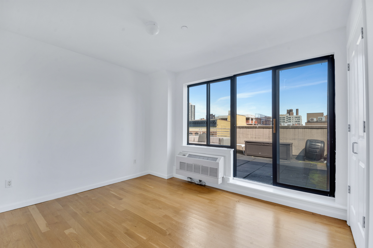 416 East 117th Street, Unit PH6 Manhattan, NY 10035 - Photo 11 of 18 a view of empty room with floor to ceiling window