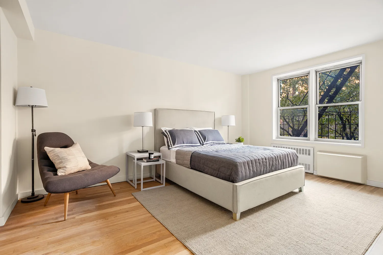 a bedroom with a bed chair and window