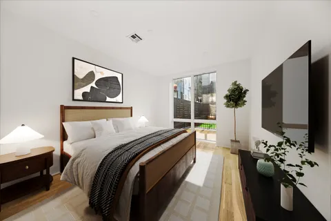 a bedroom with a bed and a flat screen tv