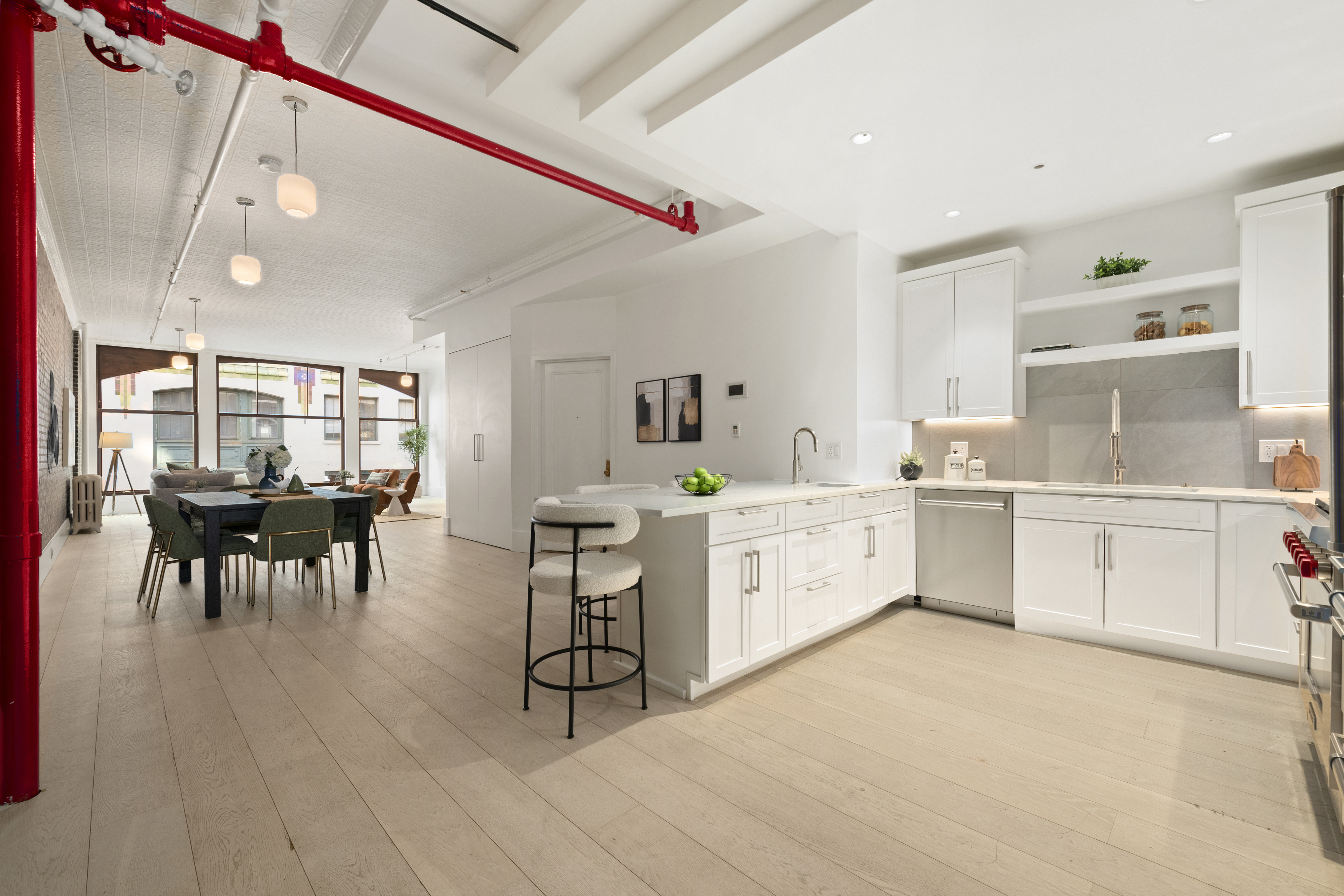 48 West 22nd Street, Unit 2 Manhattan, NY 10010 - Photo 3 of 8 a large white kitchen with cabinets a sink and appliances