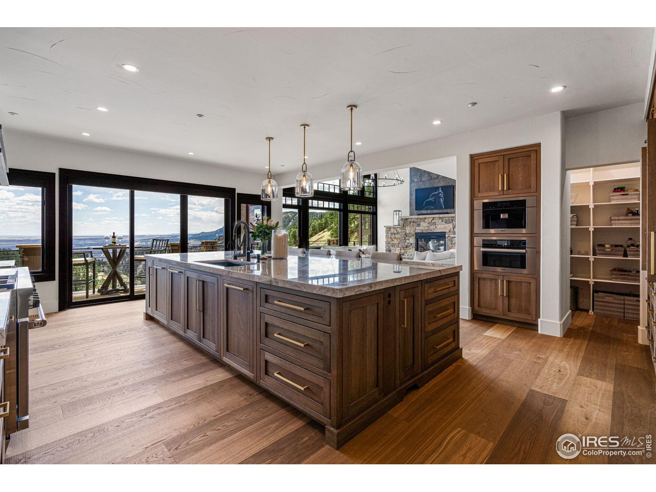 166 Valley View Way Boulder, CO 80304 - Photo 8 of 40 a kitchen with stainless steel appliances kitchen island granite countertop a large cabinets a sink and wooden floor