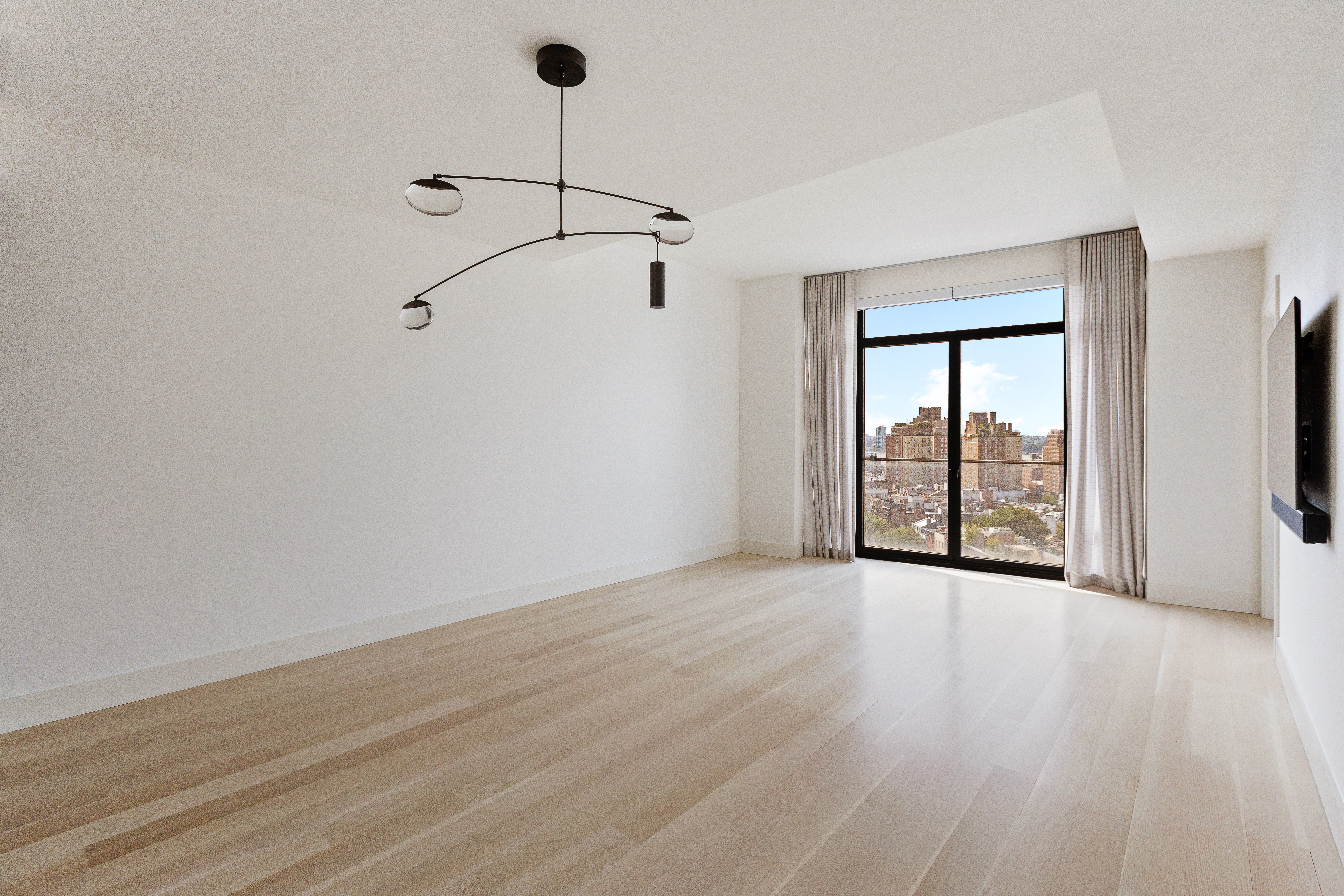 155 West 11th Street, Unit 14D Manhattan, NY 10011 - Photo 1 of 12 a view of an empty room with wooden floor and a window