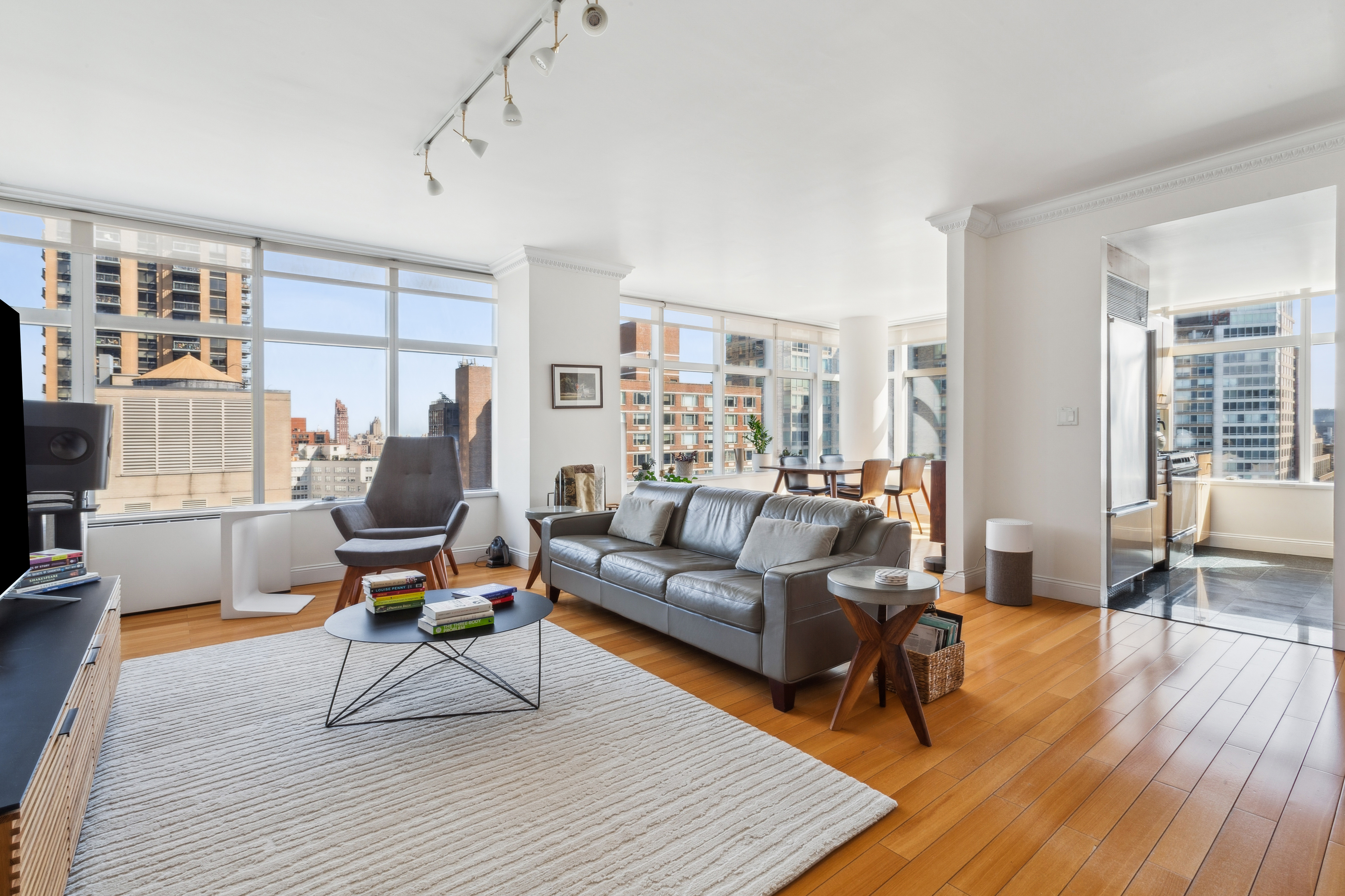 a living room with furniture a rug and a large window