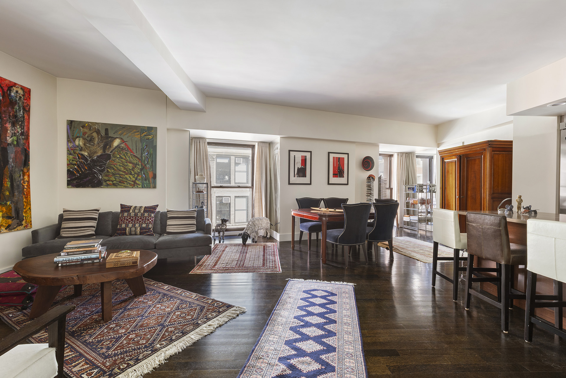 a living room with furniture a rug and a table