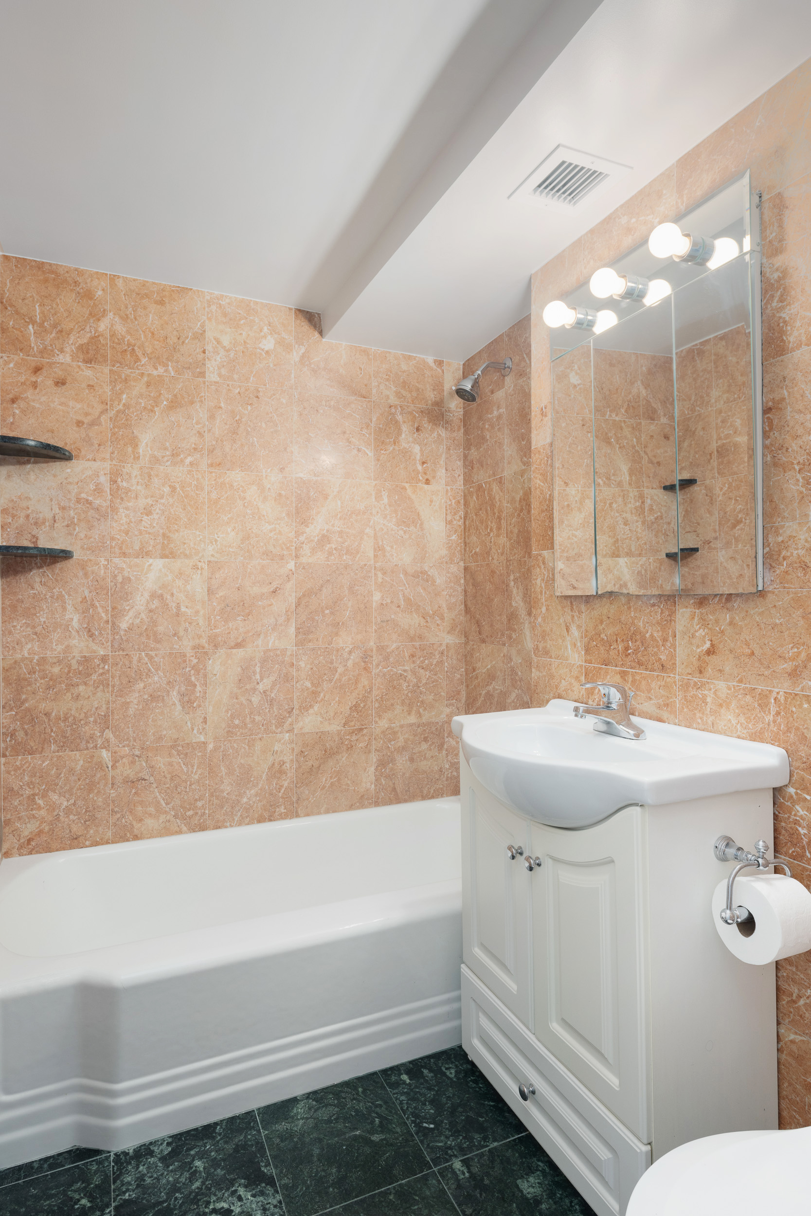 460 East 79th Street, Unit 15F Manhattan, NY 10075 - Photo 6 of 8 a bathroom with a sink a toilet and shower