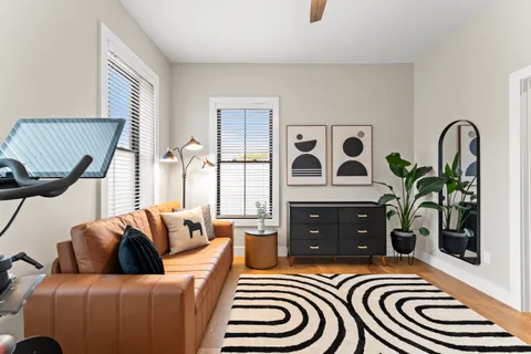 a bedroom with furniture and wooden floor