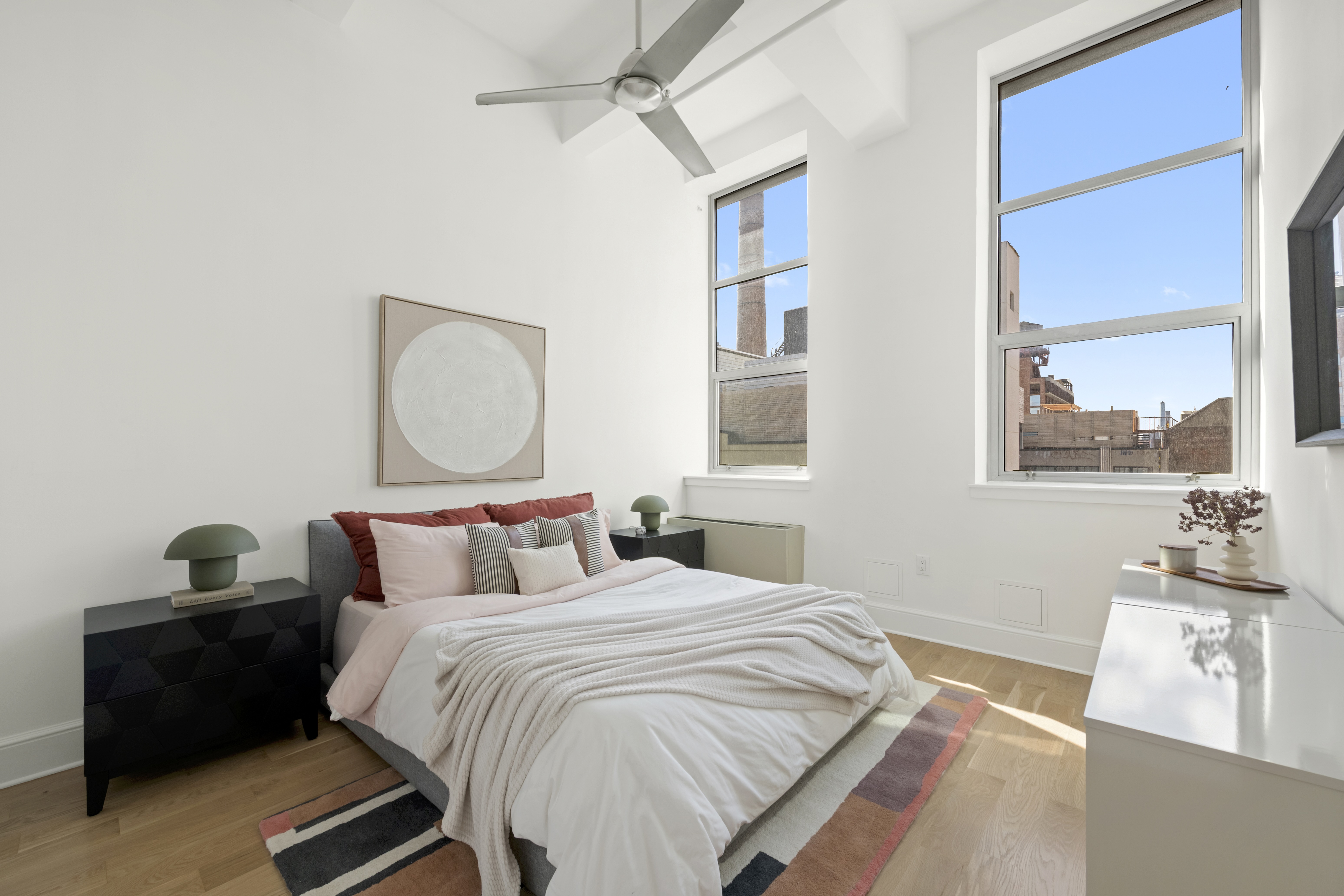 55 Berry Street, Unit 4B Brooklyn, NY 11249 - Photo 4 of 12 a bedroom with a bed and wooden floor