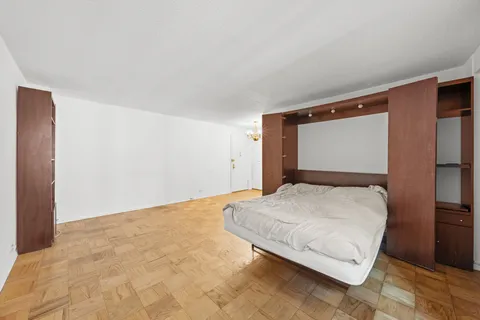 a bedroom with a bed and a dresser