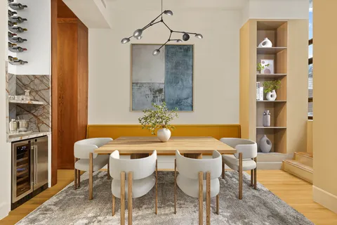 a dining room with a table and chairs