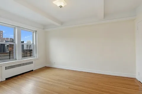 a bath room with a table and a chair