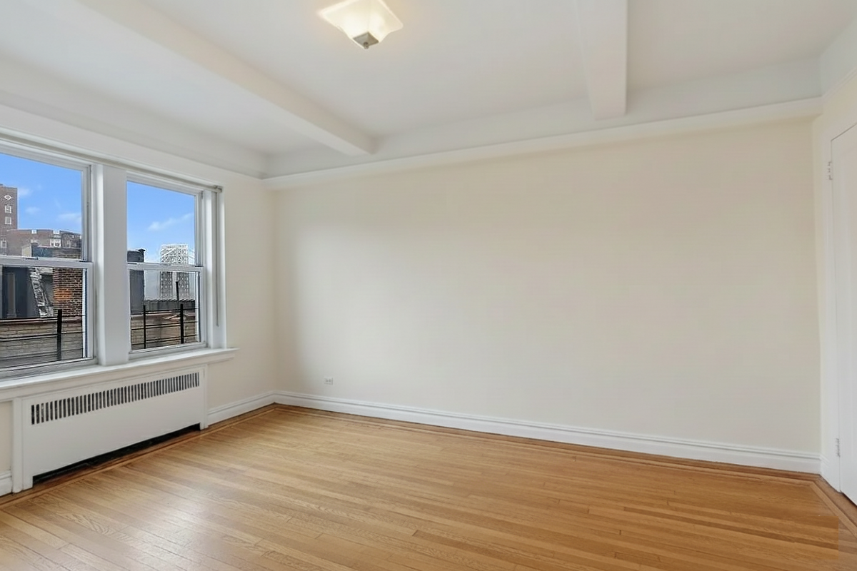 250 Cabrini Boulevard, Unit 9E Manhattan, NY 10033 - Photo 10 of 19 an empty room with wooden floor and windows