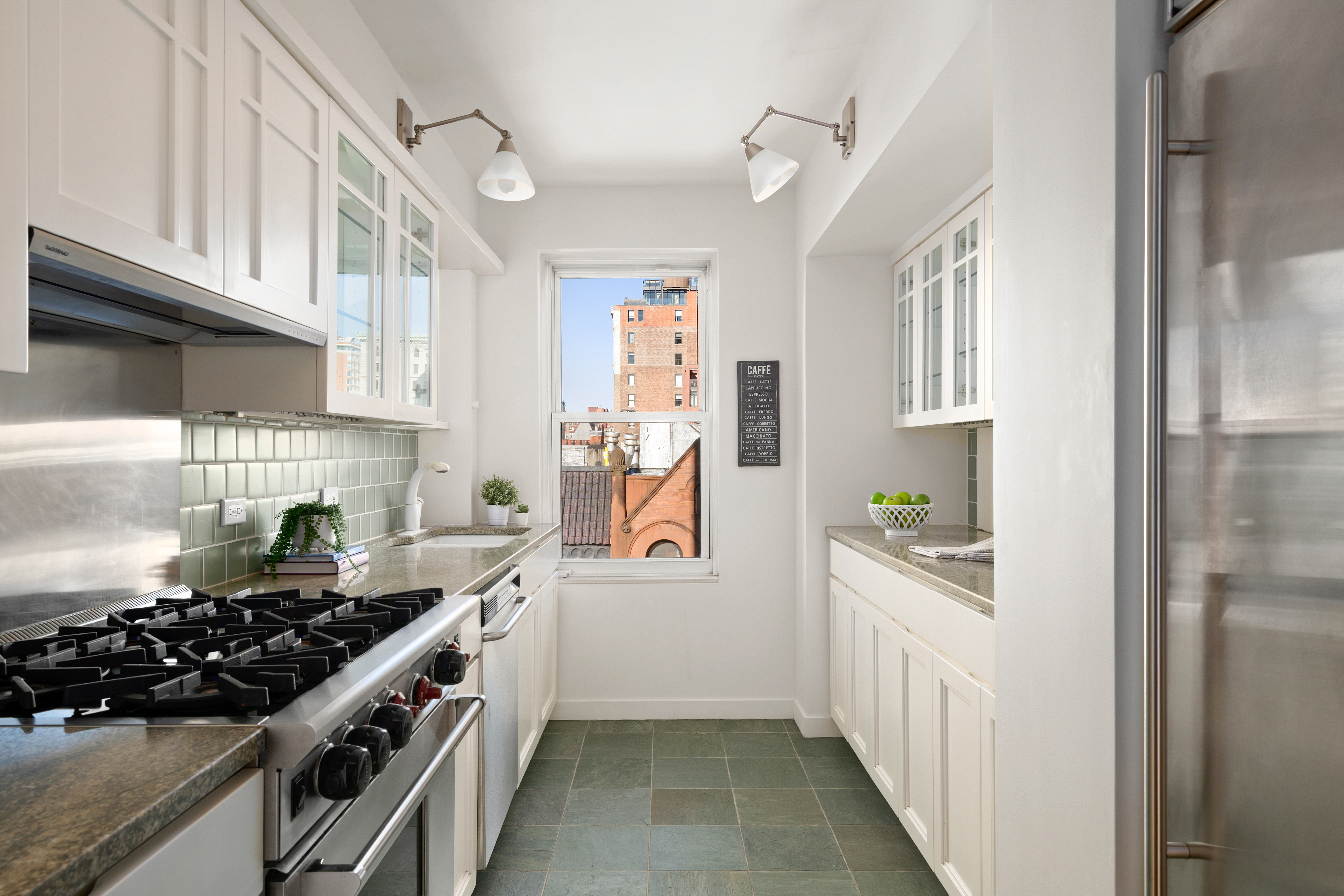 336 West End Avenue, Unit 7CD Manhattan, NY 10023 - Photo 5 of 16 a kitchen with stainless steel appliances a stove and a refrigerator