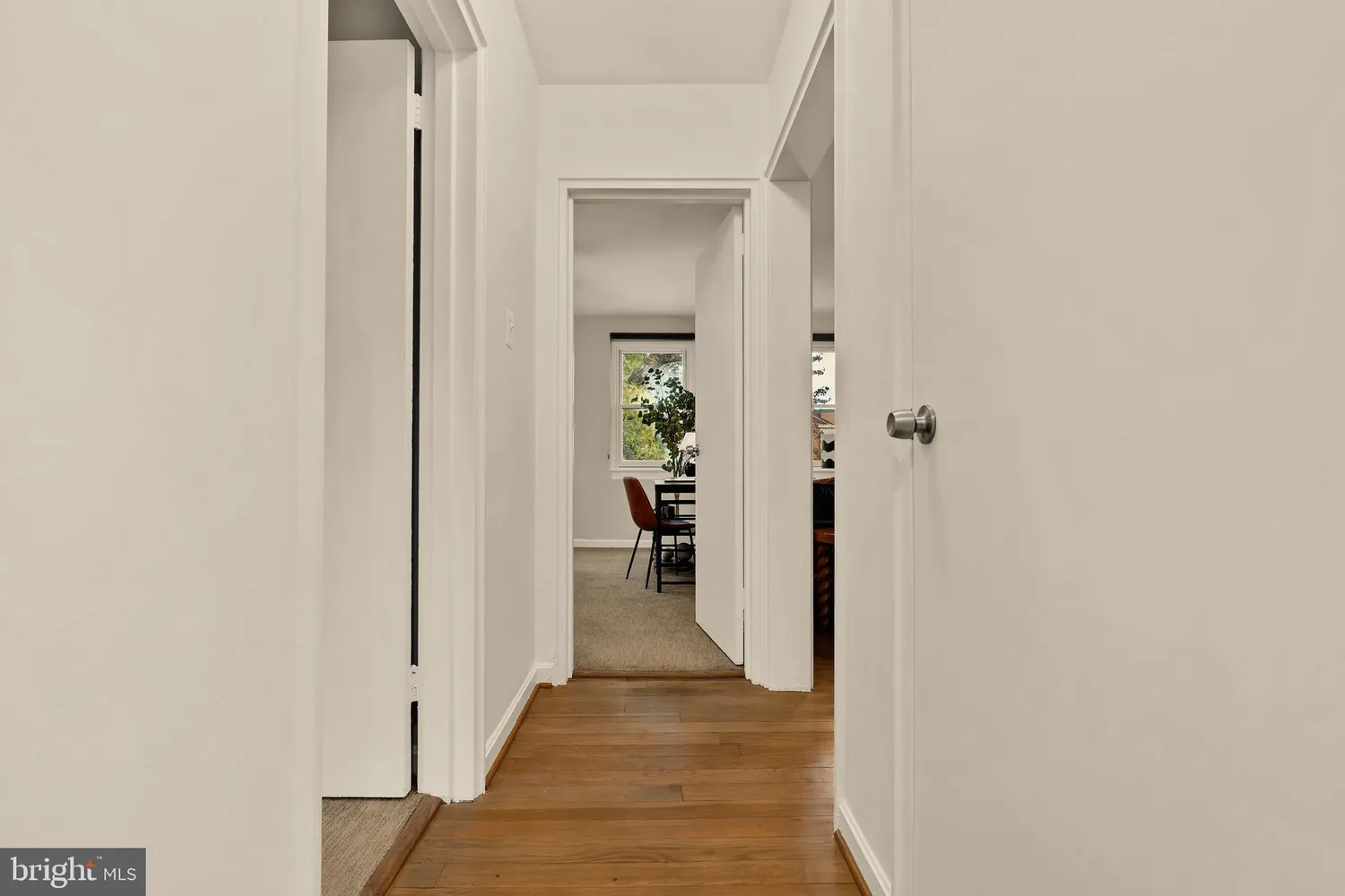 a view of a hallway with wooden shelves