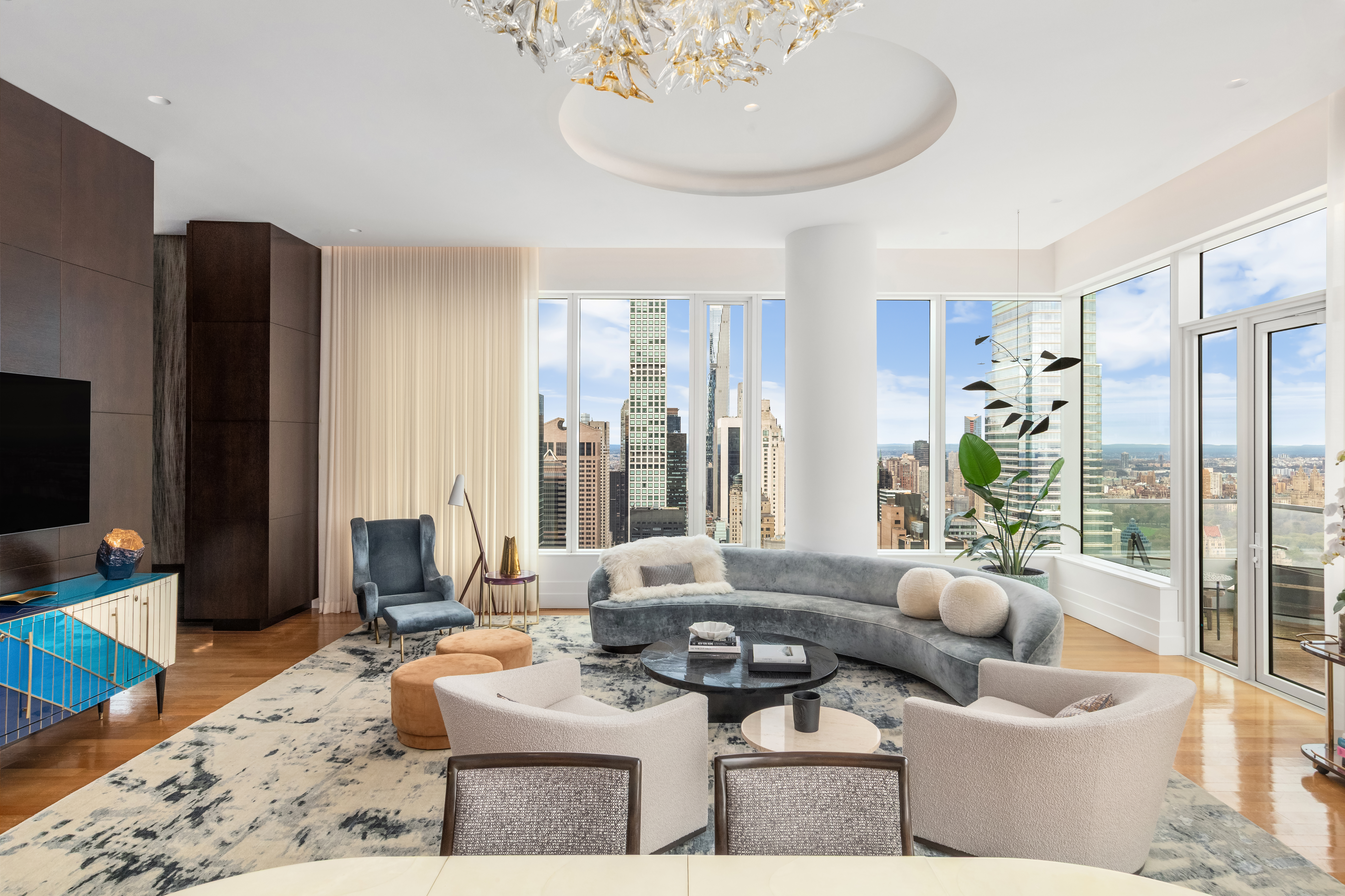 252 East 57th Street, Unit 60A Manhattan, NY 10022 - Photo 2 of 28 a living room with furniture and a flat screen tv