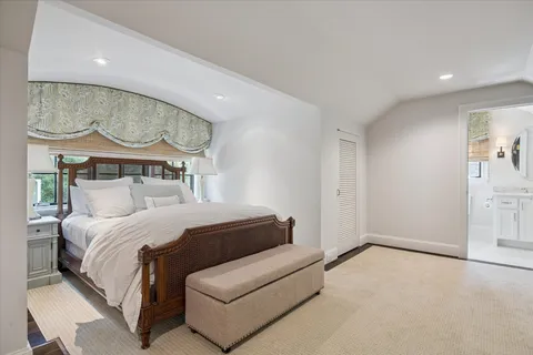 a living room with furniture a flat screen tv and a floor to ceiling window