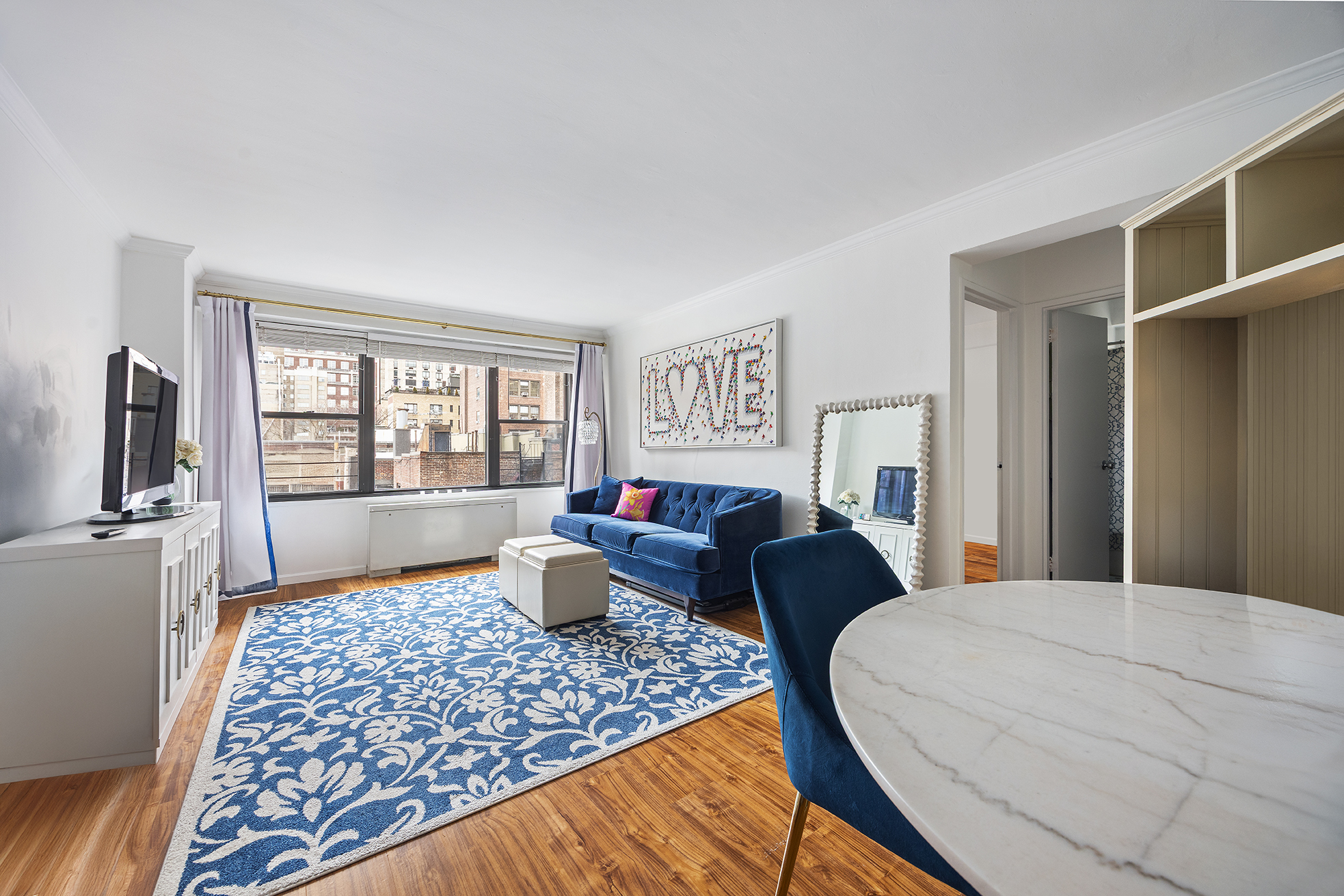 120 East 90th Street, Unit 7B Manhattan, NY 10128 - Photo 2 of 8 a bedroom with a bed and glass window