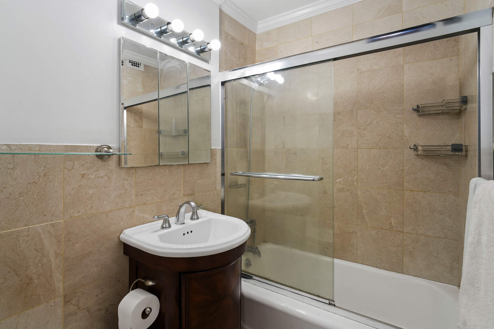 321 East 45th Street, Unit 1F Manhattan, NY 10017 - Photo 7 of 14 a bathroom with a sink shower and a mirror