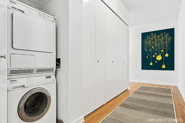252 7th Avenue, Unit 10I Manhattan, NY 10001 - Photo 14 of 25 a view of entryway with washer and dryer