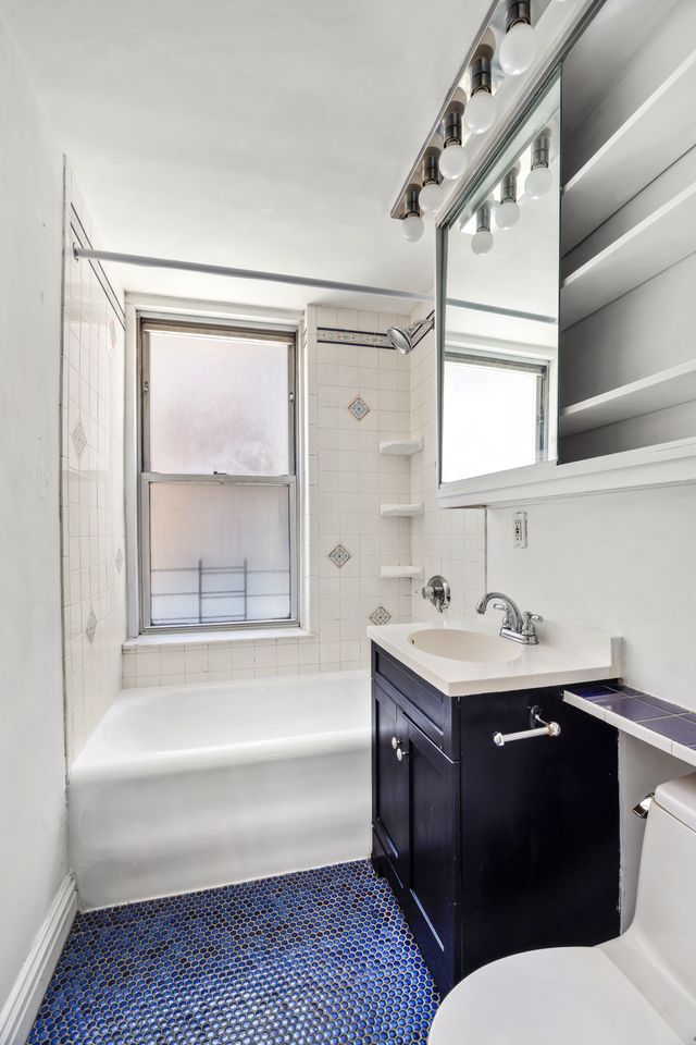 325 West 45th Street, Unit 205 Manhattan, NY 10036 - Photo 6 of 14 a bathroom with a sink and a bathtub