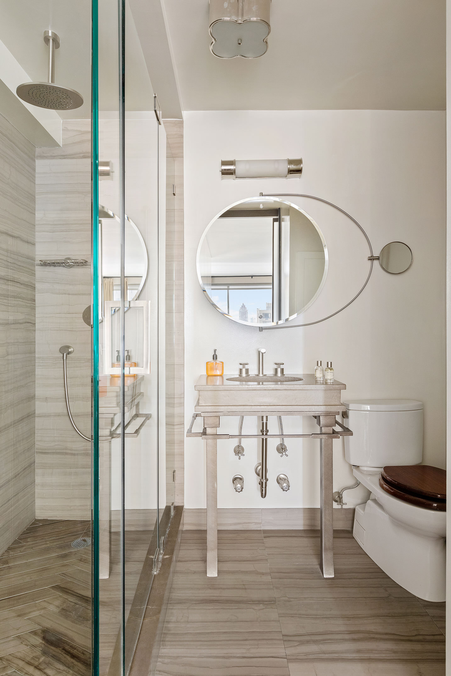 40 East 80th Street, Unit 24A Manhattan, NY 10075 - Photo 9 of 11 a bathroom with a sink and a mirror